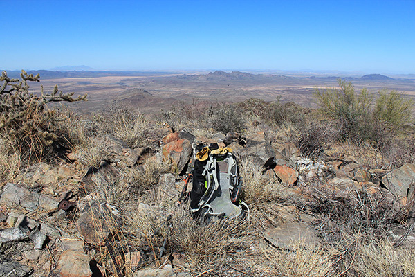 My pack leans against the summit cairn where the benchmark is located