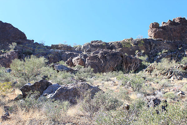 Cliffs protect access to the notch. The carved ramp starts on the right and leads up to the left.