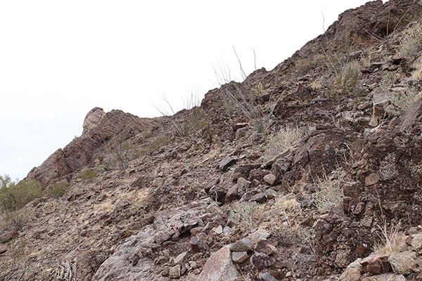 I make slow but steady progress traversing loose gravel ledges and climbing short rock bands