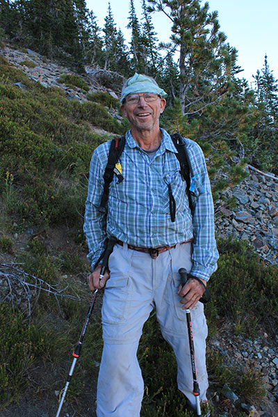 Larry climbing talus slopes on the west face of Red Mountain
