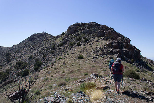 Higher, we climb towards a communications facility. The summit lies just beyond it.