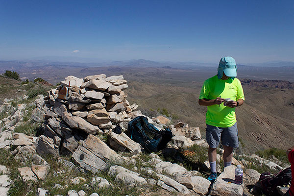 The Mount Perkins summit cairn with mailbox summit registry container. and PERKINS benchmark.