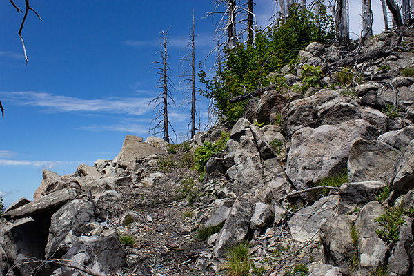 The trail passes to the west of the rocky point