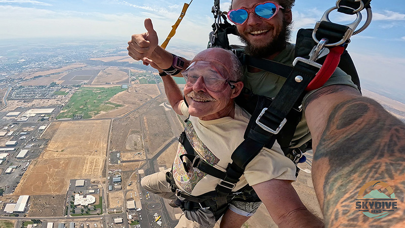 The main chute has opened and Nick coaches me on steering. We locate the landing zone.