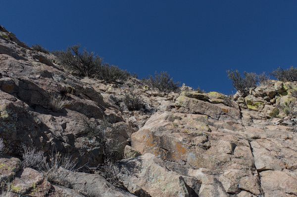 My route leads me up this slab face to easier climbing above