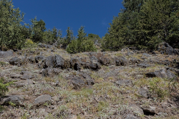 Climbing open slopes towards the rocky Southwest ridge above