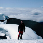 Paul on Volcán Cotopaxi with Volcán Chimborazo beyond